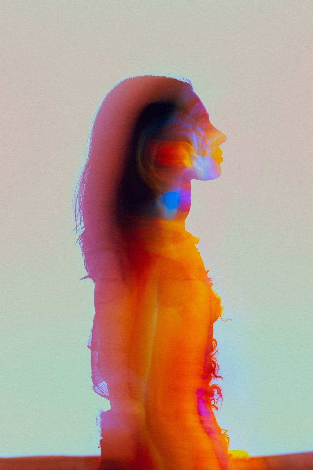Woman in profile with light refracting across her face