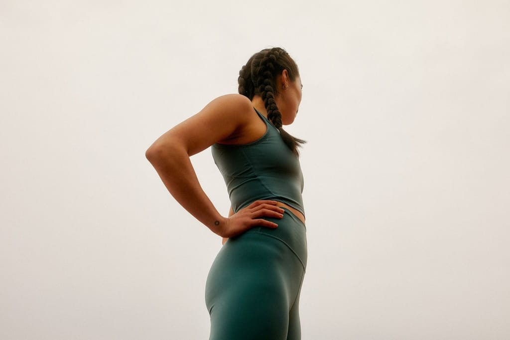 Woman in activewear with hands on her hips